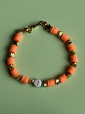 Orange lettered bracelet with a 'J' size 17.5cm