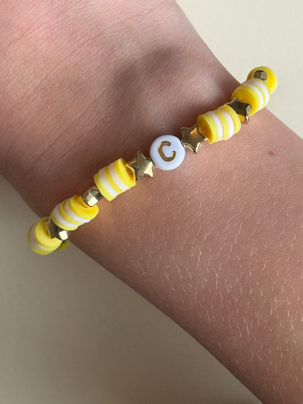Yellow and white lettered bracelet with a 'C' size 17cm
